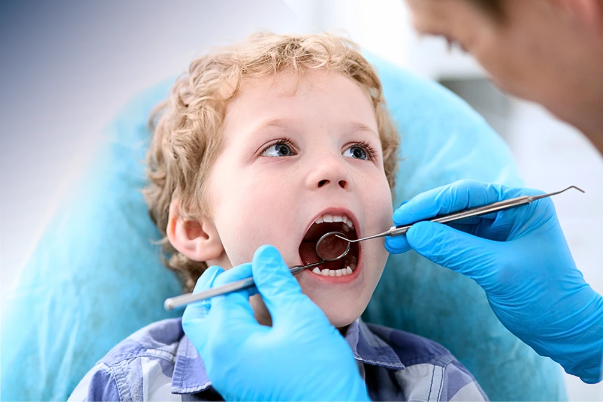 Child holding their cheek due to severe toothache, highlighting the need for prompt pediatric dental care.