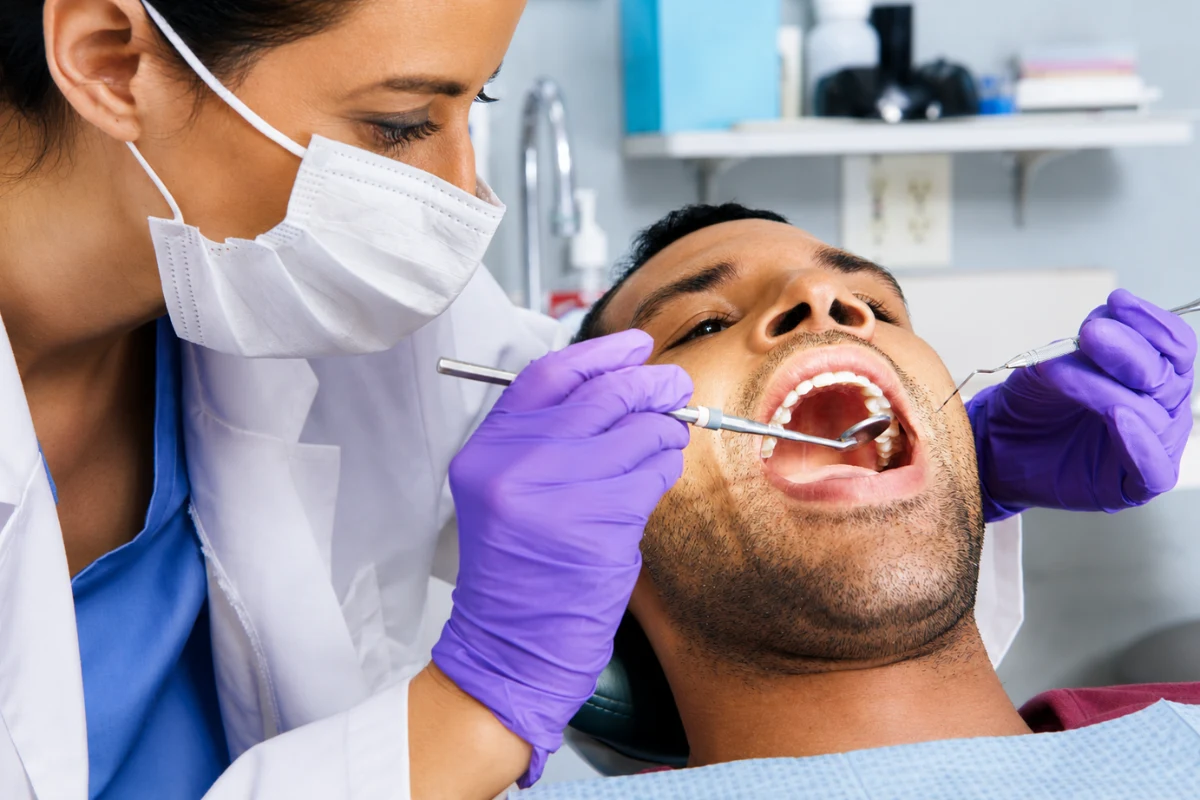 Dentist examining a patient's teeth for a broken or damaged tooth