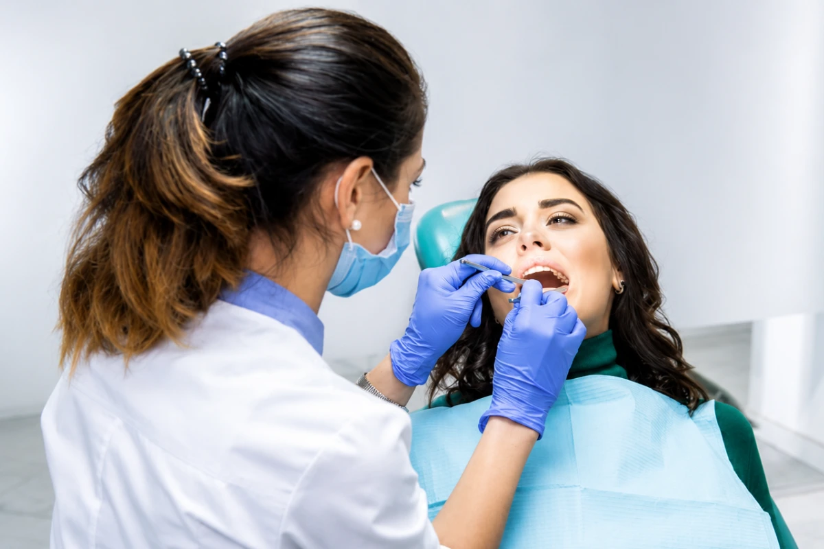 Dentist examining a patient's teeth during a dental check-up